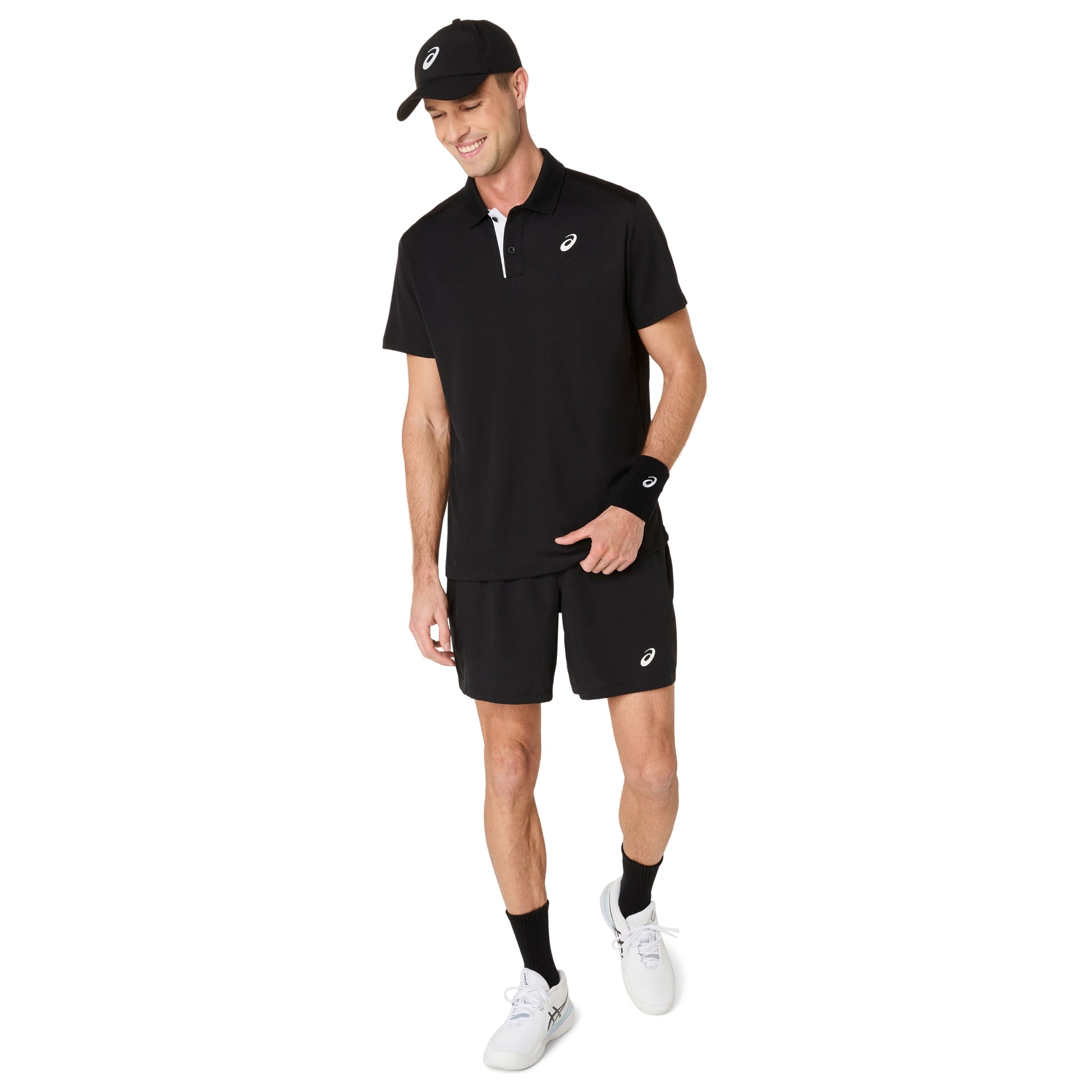 Man wearing a black polo shirt, shorts, and cap with a visible brand logo on a white background