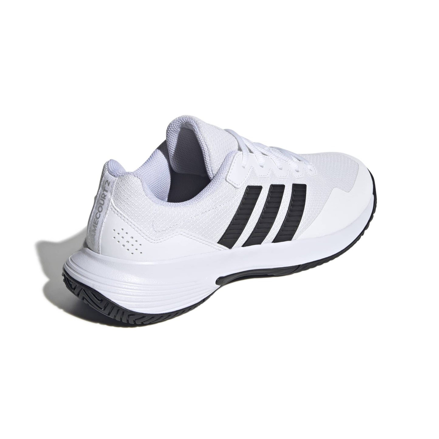 White tennis shoe with black stripes on a white background