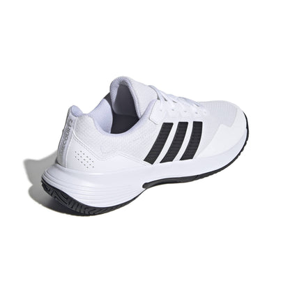 White tennis shoe with black stripes on a white background