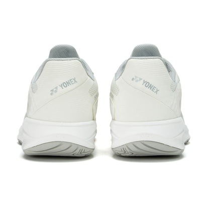White Yonex tennis shoes shown from the back on a white background