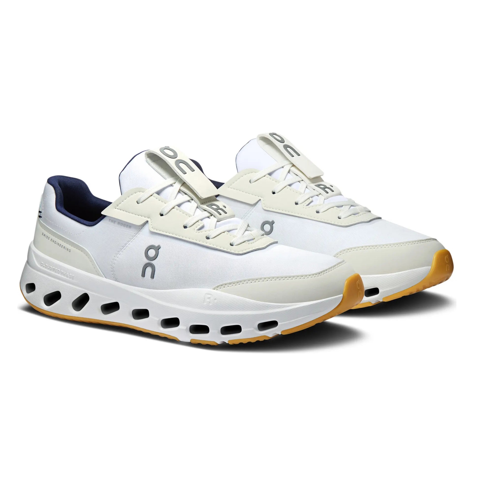 A pair of On tennis shoes in white and beige with navy blue lining and a gum outsole, shown on a clean white background.