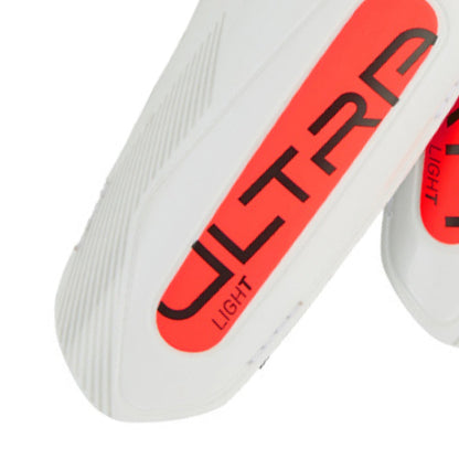Close-up of a white sneaker with red and black 'Ultra Light' branding on a white background