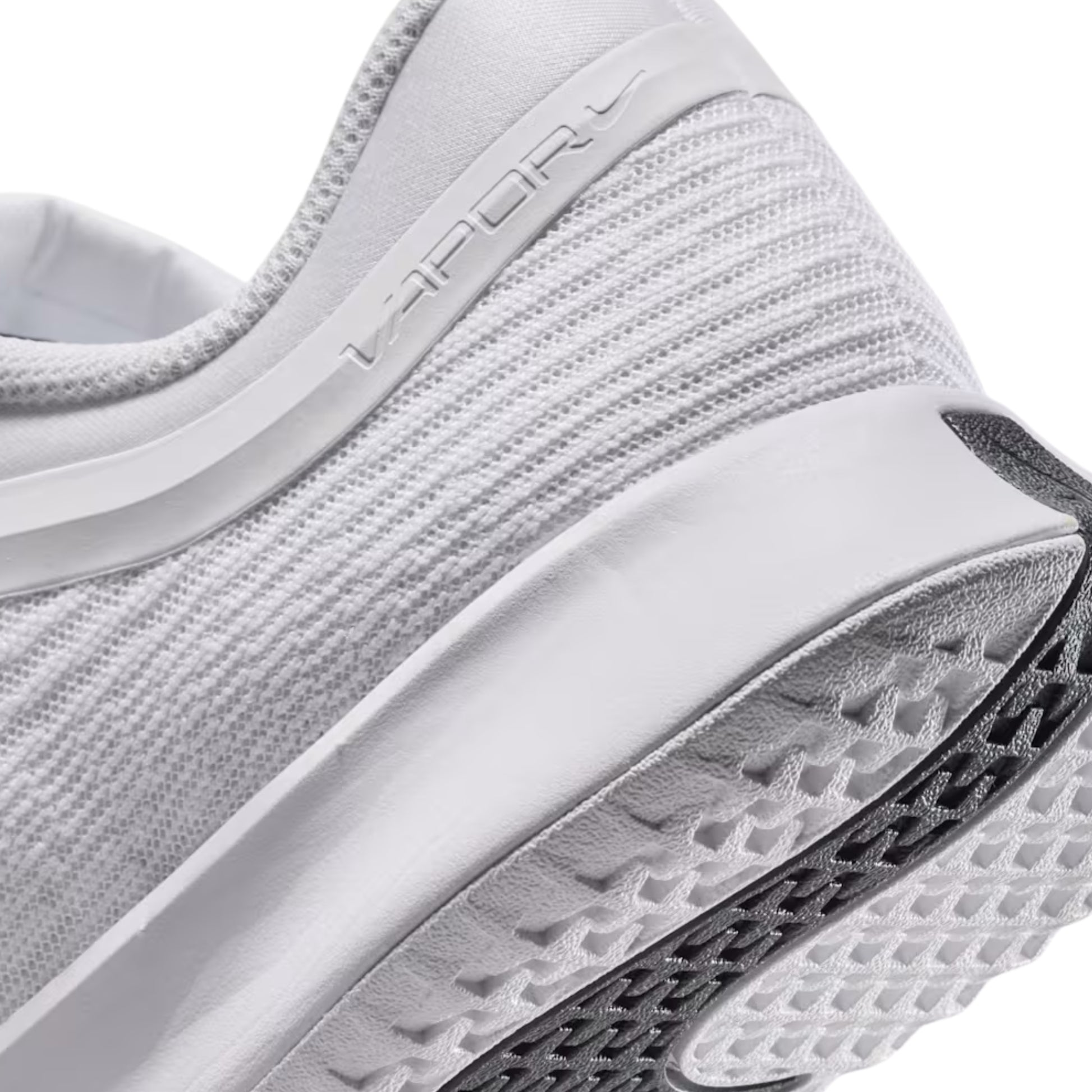 Close-up of a white tennis shoe with 'Vapor' branding on a white background