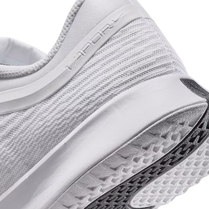 Close-up of a white tennis shoe with 'Vapor' branding on a white background