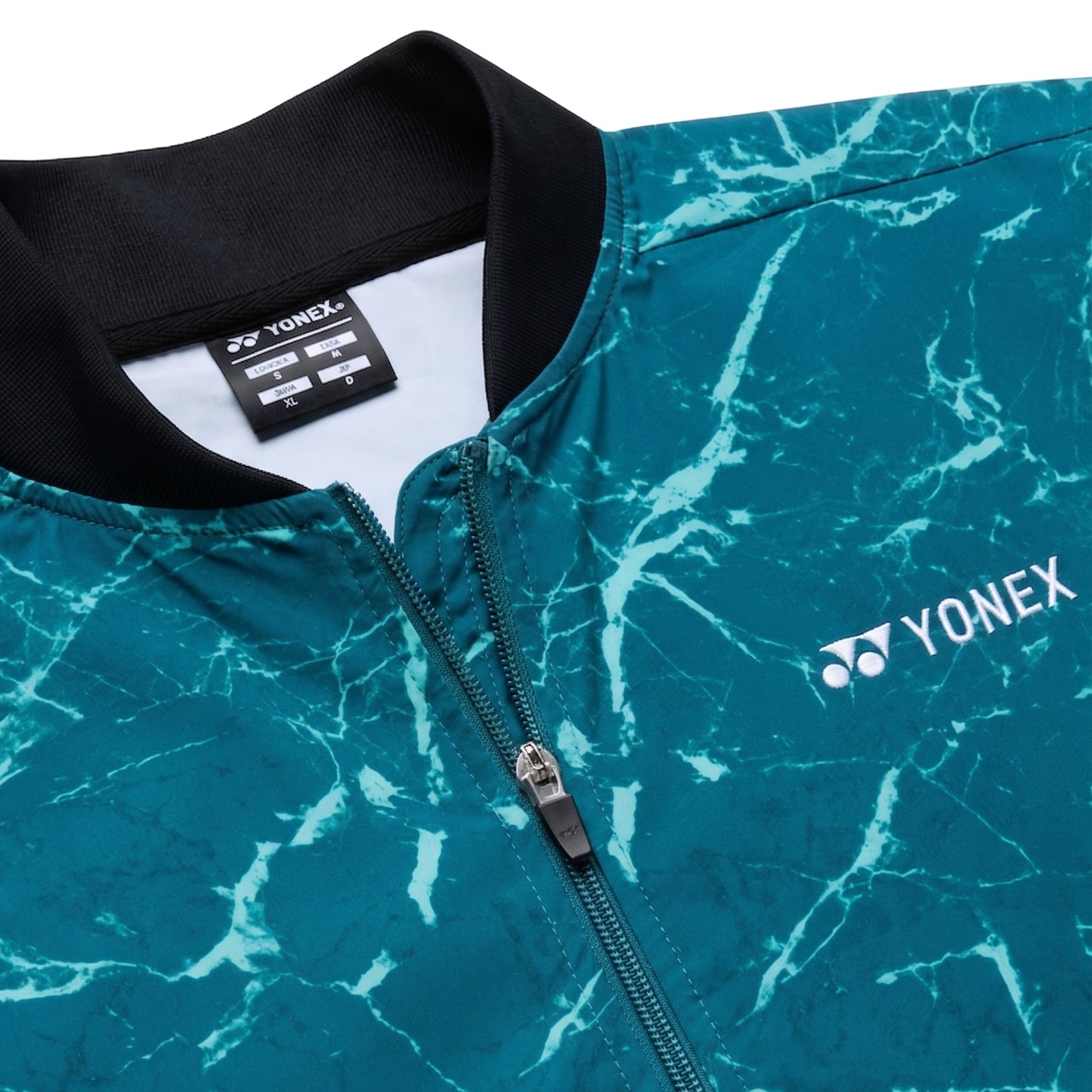 Teal marbled jacket with Yonex logo on a white background