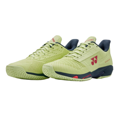 Pair of green Yonex shoes with a brand logo on a white background