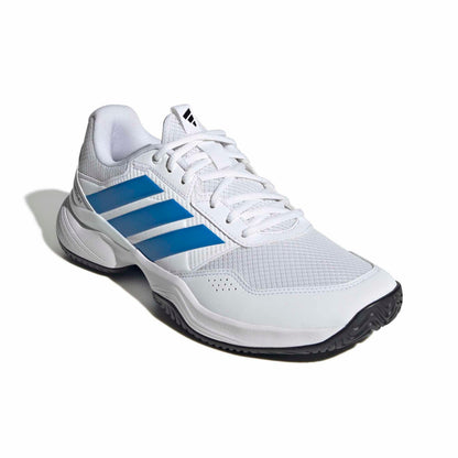 White adidas tennis shoe with blue a blue logo with a black sole on a white background.