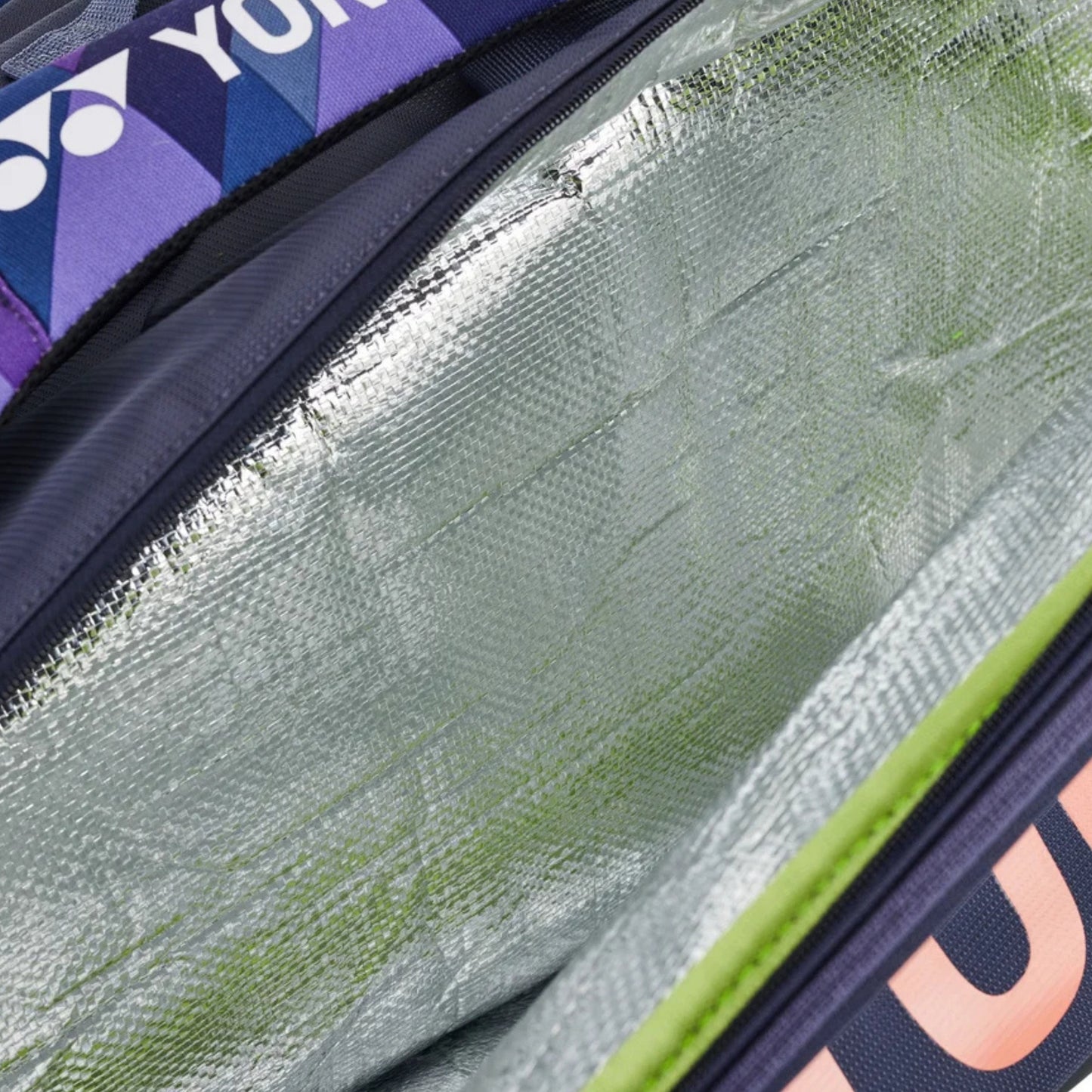 Close-up of a tennis bag with visible branding, focusing on the texture and design details.
