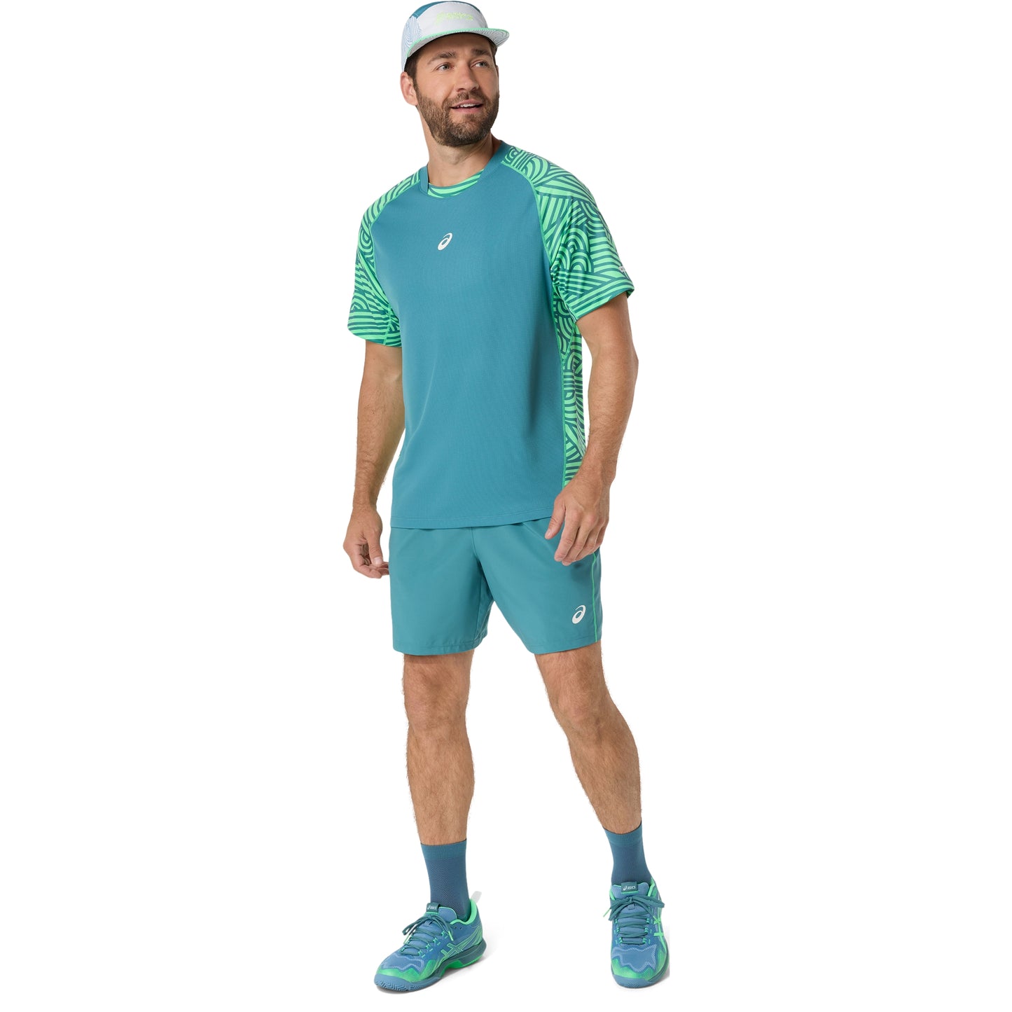 Man wearing a teal athletic outfit with a white background