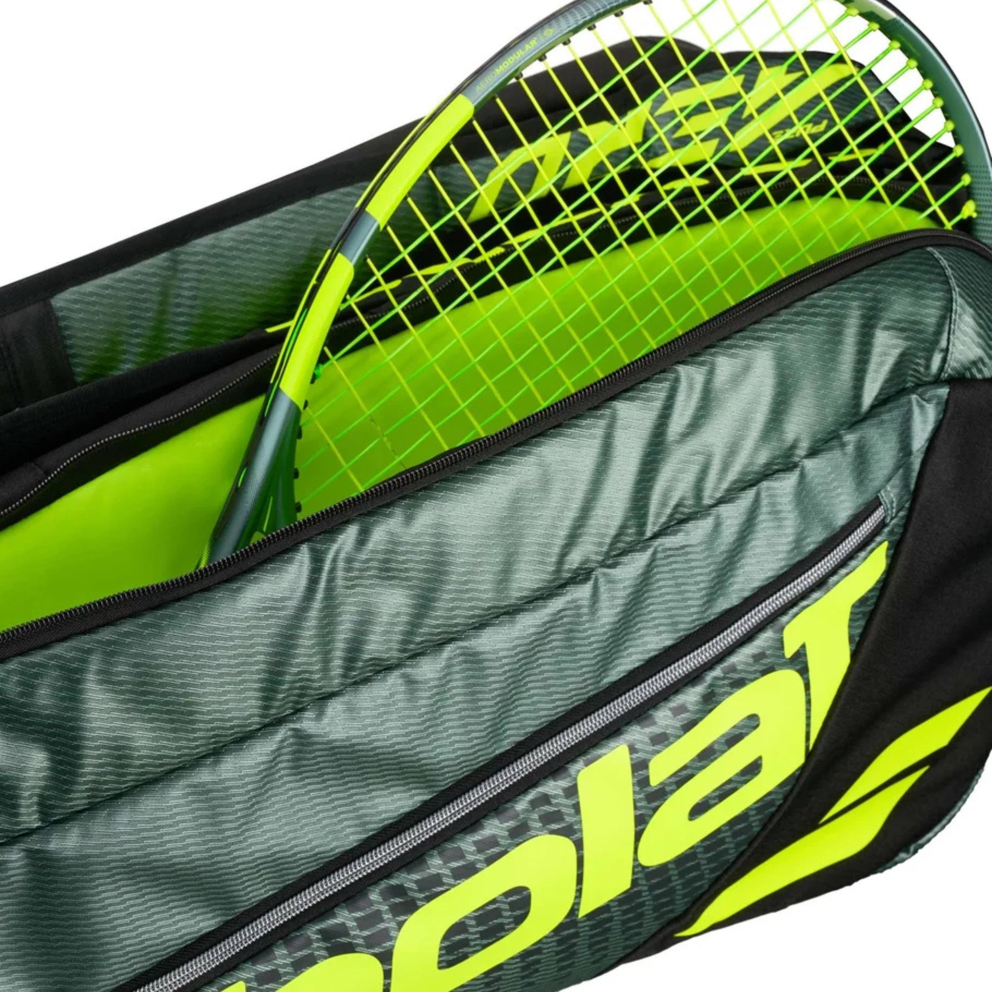 Tennis racket with green frame inside a Babolat bag.