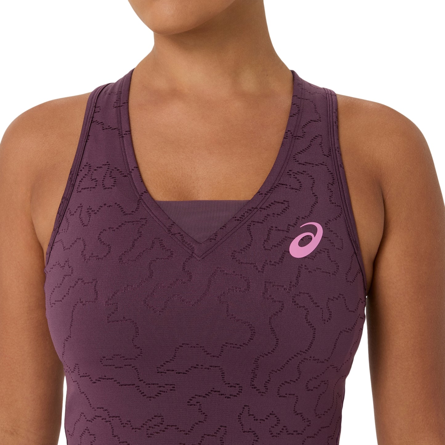 Close-up of a woman wearing a sleeveless athletic tank top in dark plum purple with a tonal wavy pattern and a pink ASICS logo on the chest, against a plain white background.