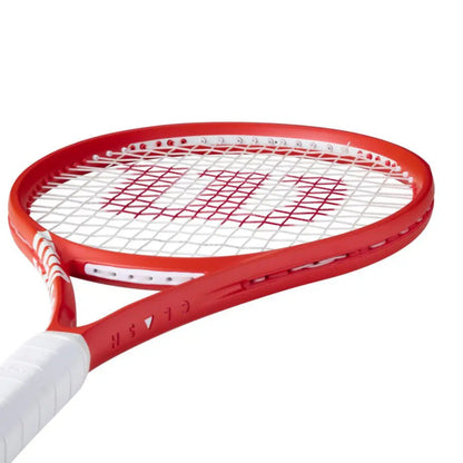 Red tennis racket with white handle on a white background