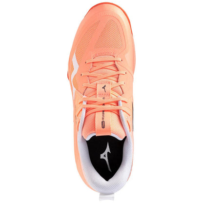 A single Mizuno squash shoe in a vibrant coral-orange colorway, shown from a top-down perspective on a solid white background.