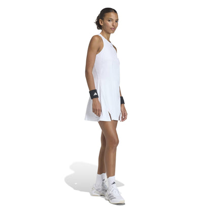 Woman wearing a white tennis adidas dress on a white background