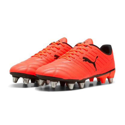 Pair of bright red rugby boots with black accents on a white background