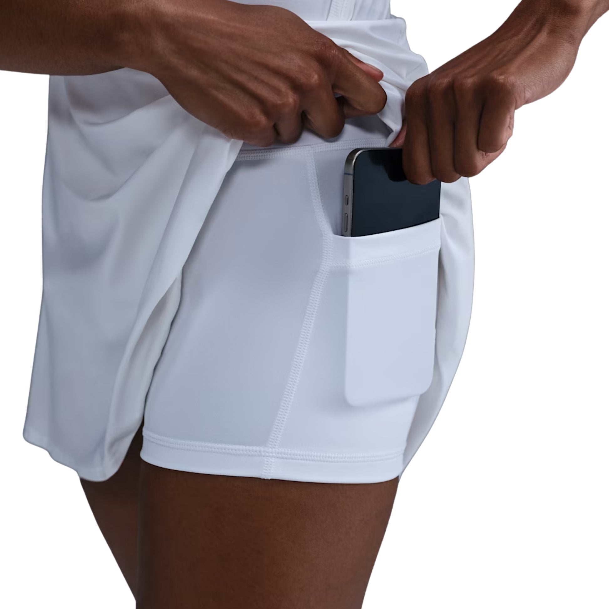 Person wearing white skirt with a pocket, holding a smartphone.
