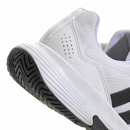 White tennis shoe with black sole and stripes on a white background