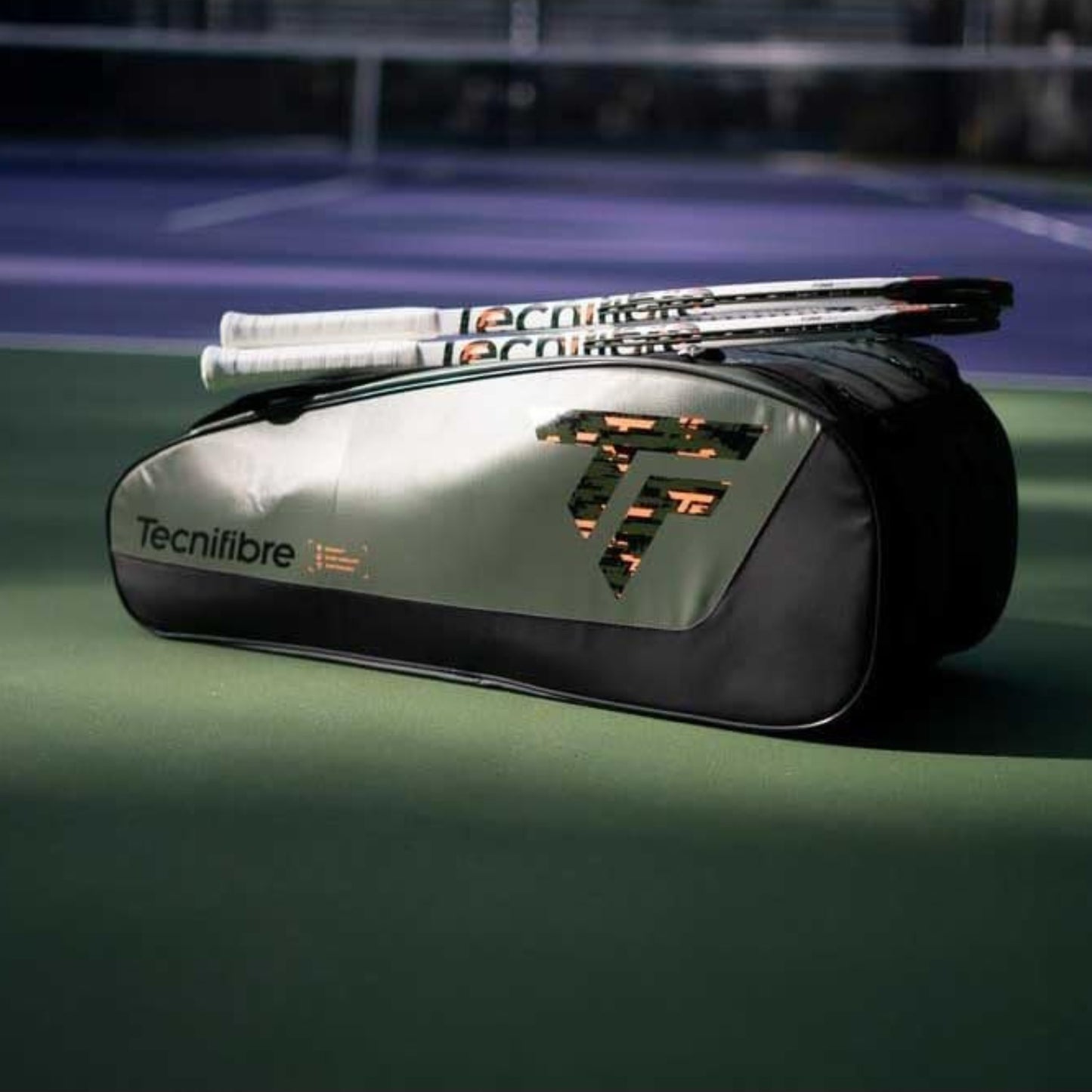 Tecnifibre tennis racket bag with rackets on a tennis court