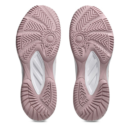 Close-up of pink shoe soles with tread pattern on a white background