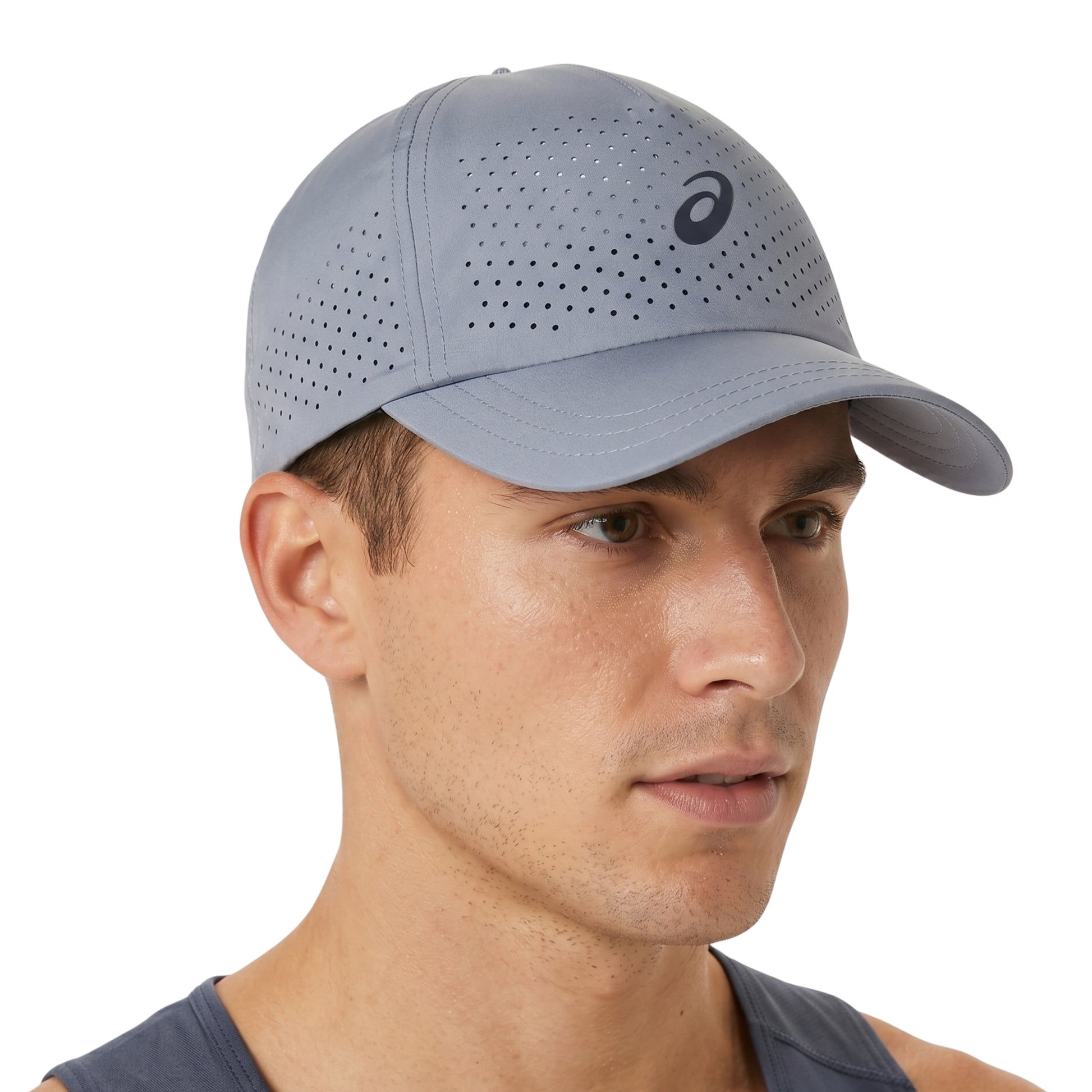 Man wearing a gray perforated Asics cap with a brand logo on a white background