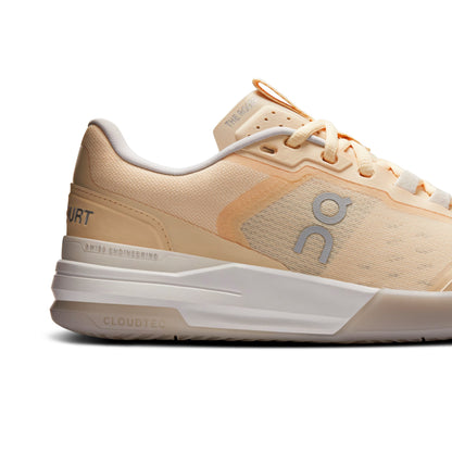 A side profile view of an On tennis shoe in a light peach and beige colorway, featuring a white CloudTec sole and a gray 'on' logo on the side panel.
