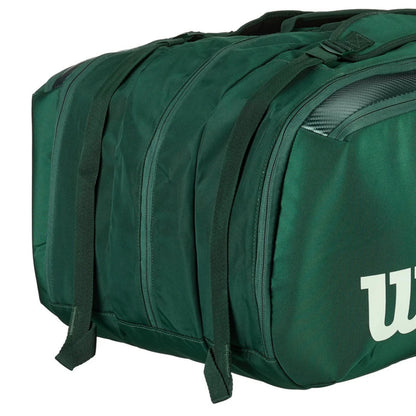 Green tennis racket bag with a visible brand logo on a white background