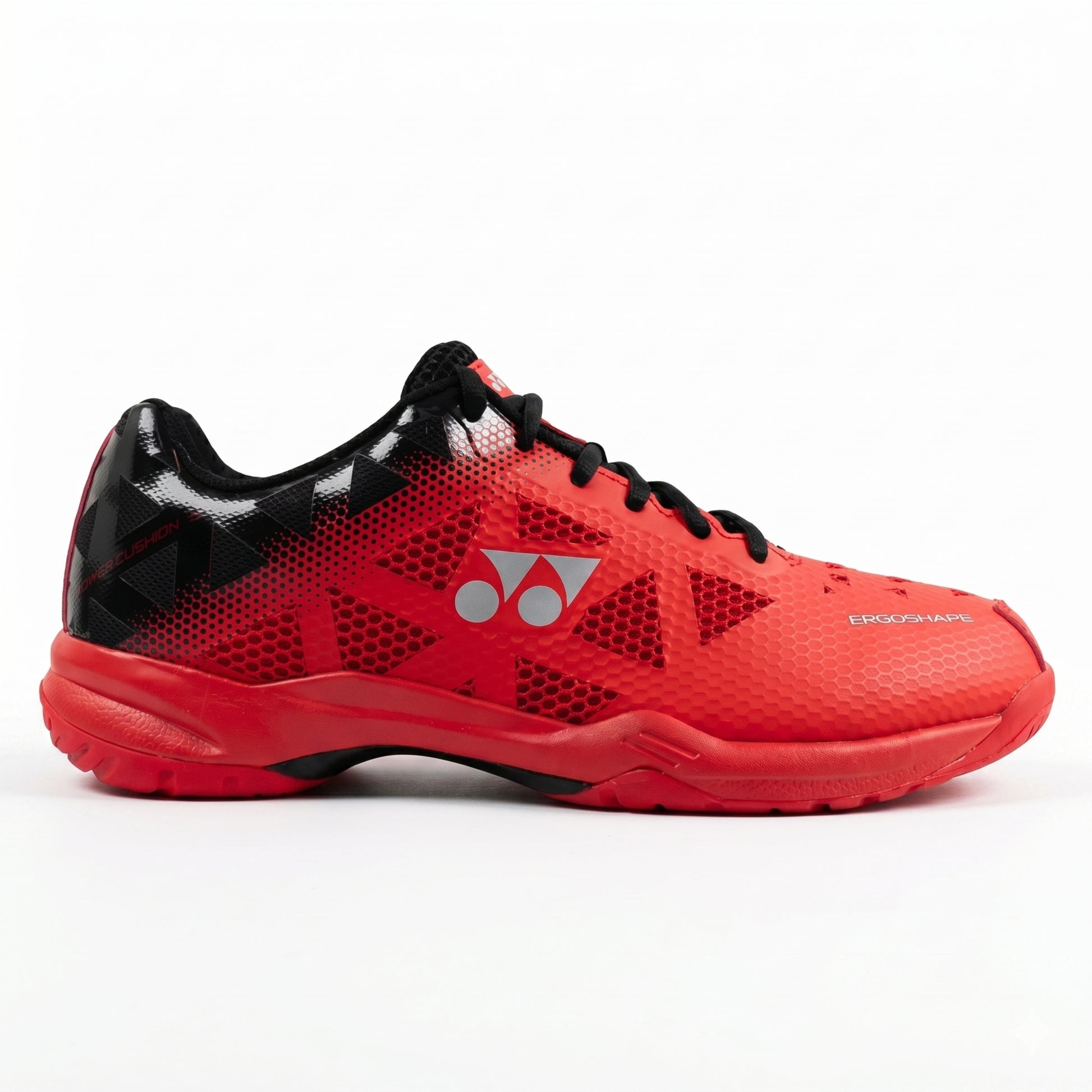 Red and black Yonex squash shoe with a brand logo on a white background