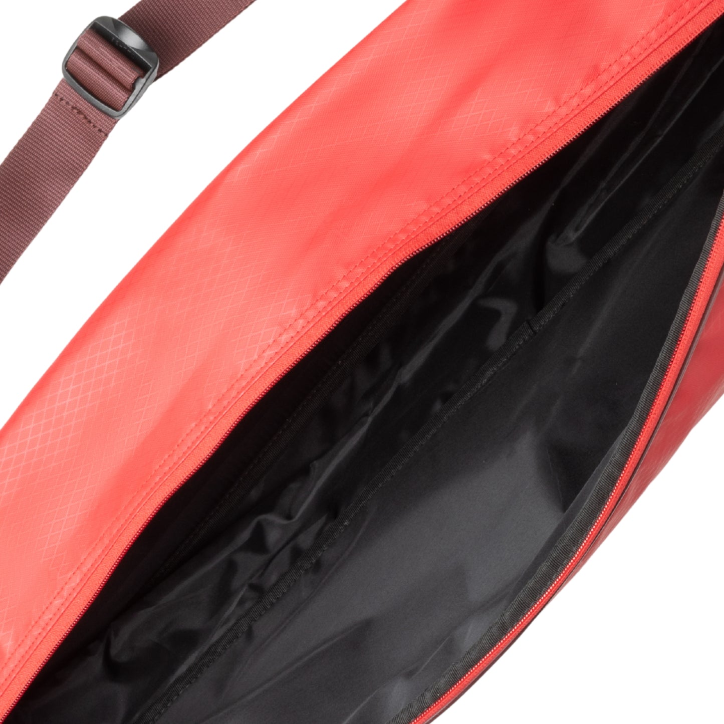 Close-up of a red bag with a strap and black interior on a white background