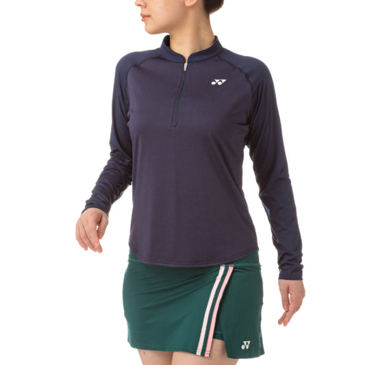 Navy long-sleeve athletic Yonex top and green skirt with a brand logo on a white background
