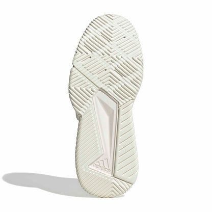 The outsole of an Adidas padel shoe in a light cream/off-white color, showing the textured tread pattern and the embossed Adidas logo near the heel, set against a plain white background with a soft shadow.