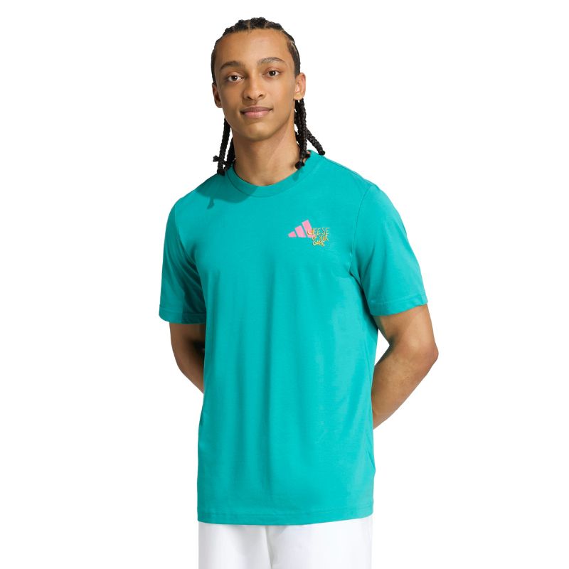 Person wearing a teal Adidas shirt with a logo on a white background