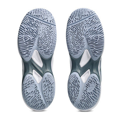 Close-up of gray tennis kids shoe soles with a textured pattern on a white background