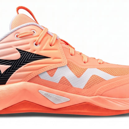 A close-up side view of a Mizuno squash shoe in a vibrant coral orange colorway, featuring a black zigzag side stripe, a white zigzag pattern on the side, and a silver MizunoEnergy logo on the midsole.