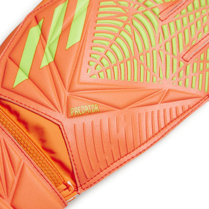 Close-up of an orange and green soccer ball with 'Predator' branding on a white background