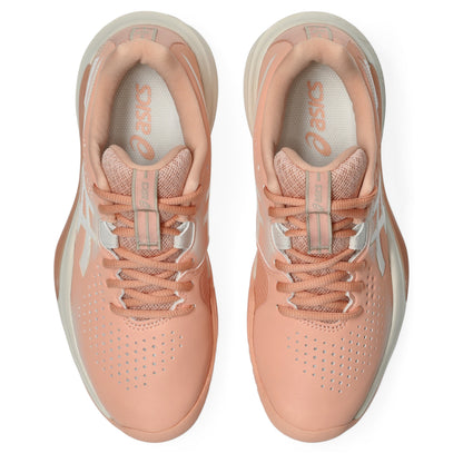A pair of ASICS tennis shoes shown from a top-down view, featuring a peach and light gray colorway with perforated uppers and matching laces.