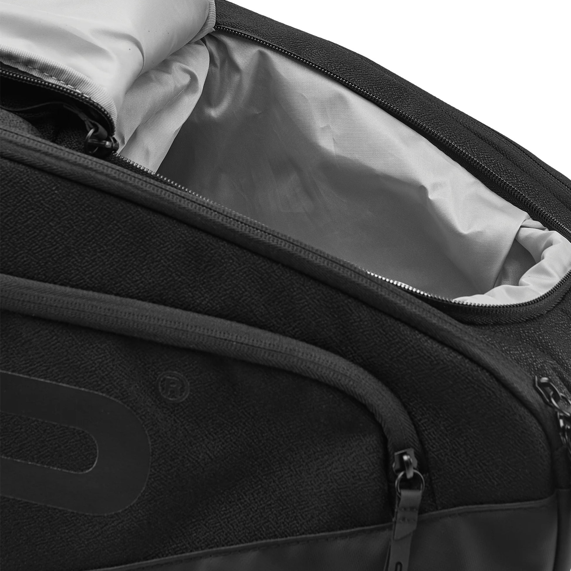 Close-up of a racket Head bag with a grey inside on a white background