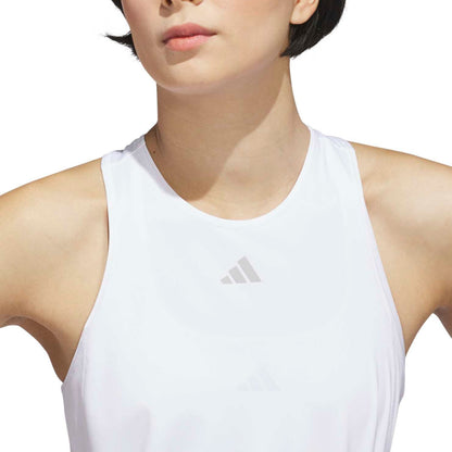 Person wearing a white Adidas tank top on a white background