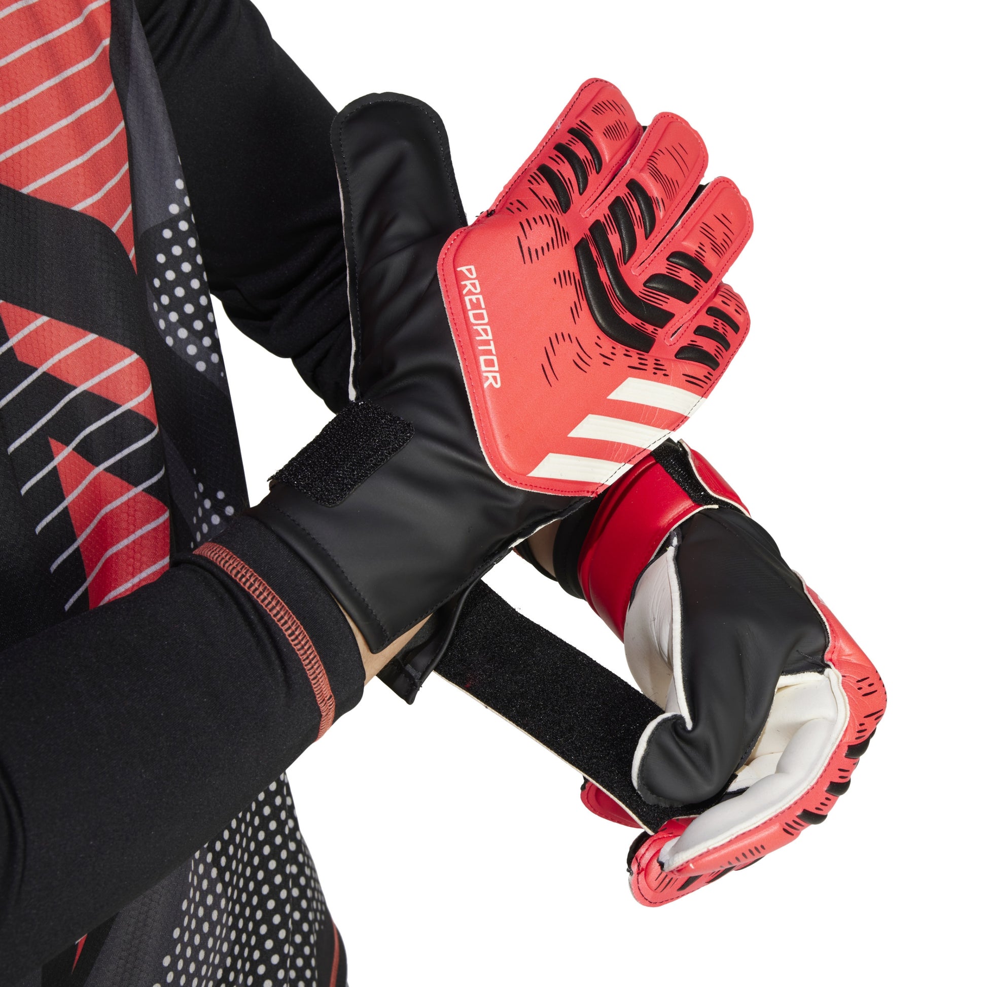 Red and black Adidas soccer gloves with 'Predator' branding on a white background