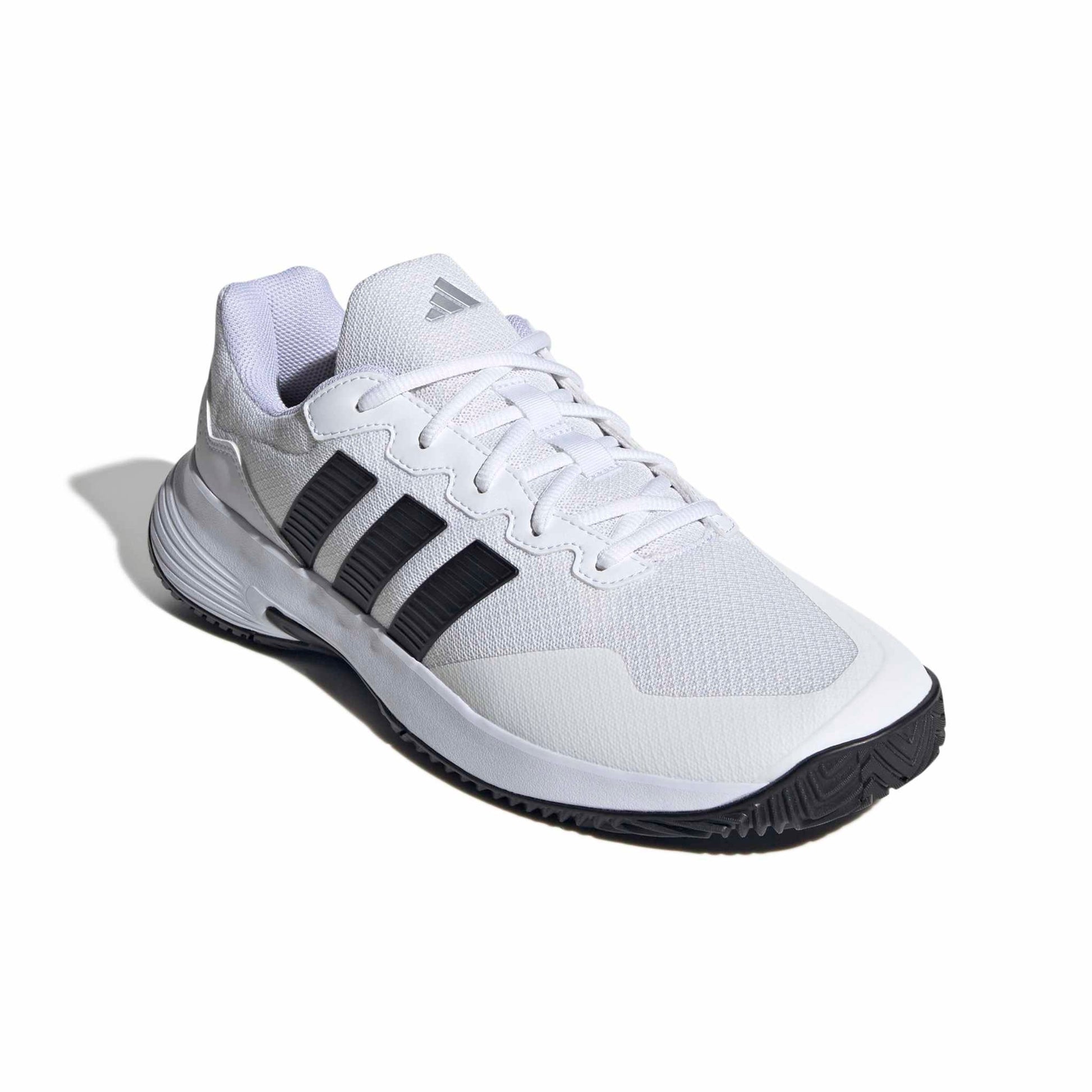 White tennis shoe with black stripes on a white background