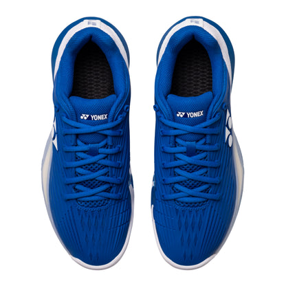 Pair of blue Yonex tennis shoes on a white background