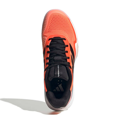 Orange and black tennis shoe on a white background