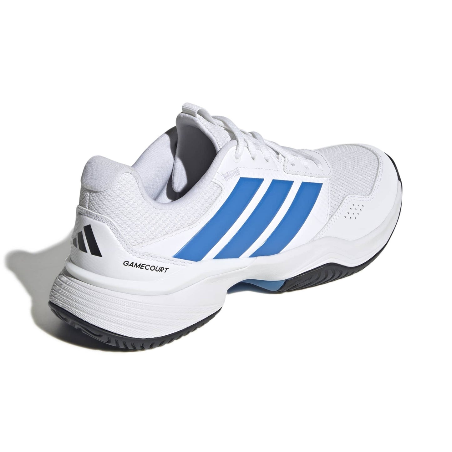 White adidas tennis shoe with blue a blue logo with a black sole on a white background.