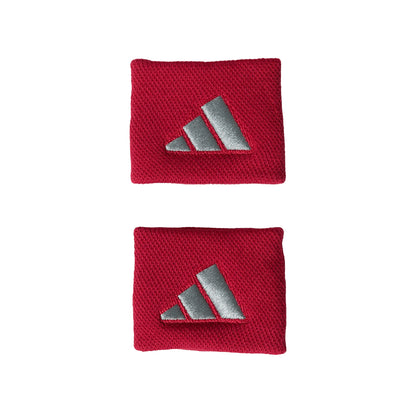 Two red wristbands with silver Adidas logo on a white background