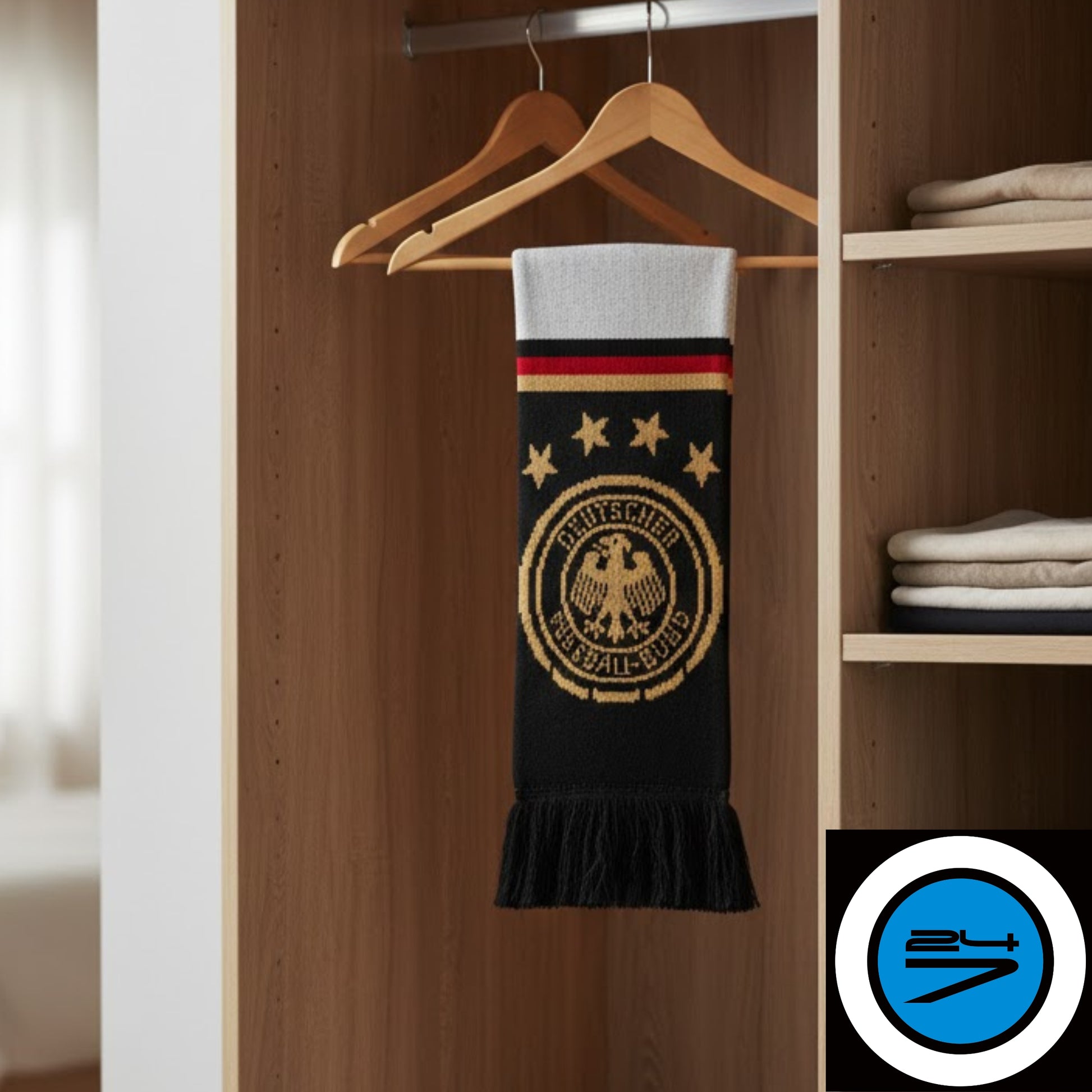 Black and gold scarf with emblem on hanger in wardrobe