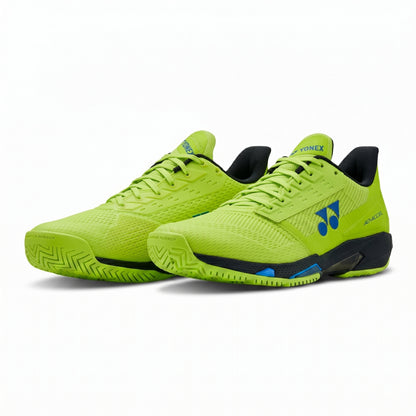 Pair of bright green Yonex shoes with black soles on a white background