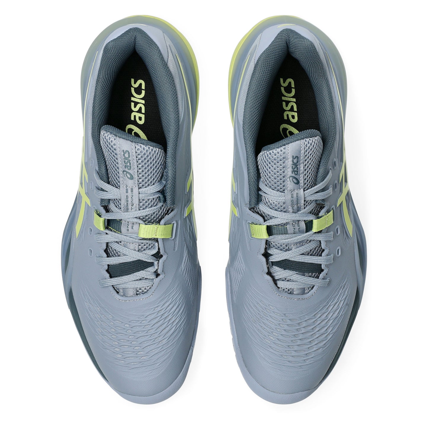 Gray tennis shoes with yellow accents and Asics logo on a white background