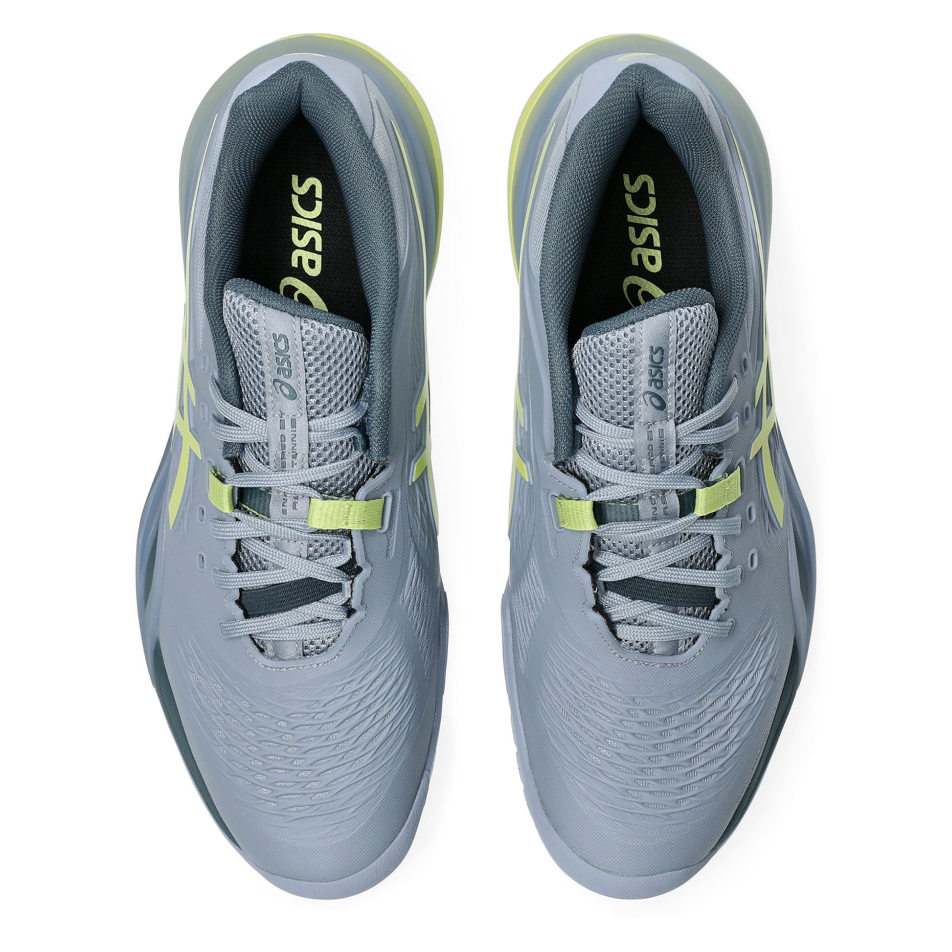 Gray tennis shoes with yellow accents and Asics logo on a white background