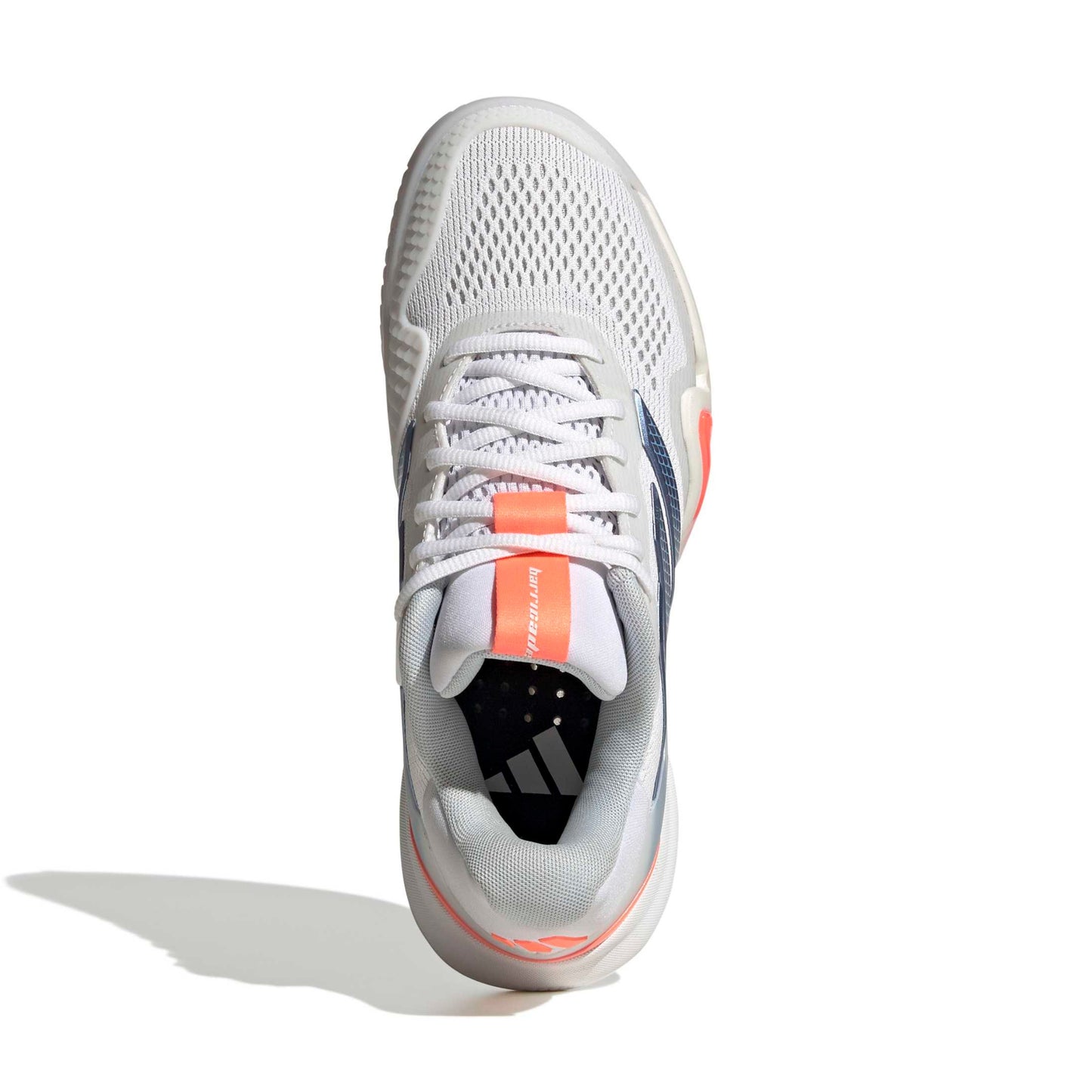 White Adidas tennis shoes with blue and orange accents on a white background