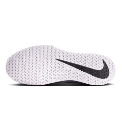 Close-up of a white tennis shoe sole with a black Nike logo on a white background
