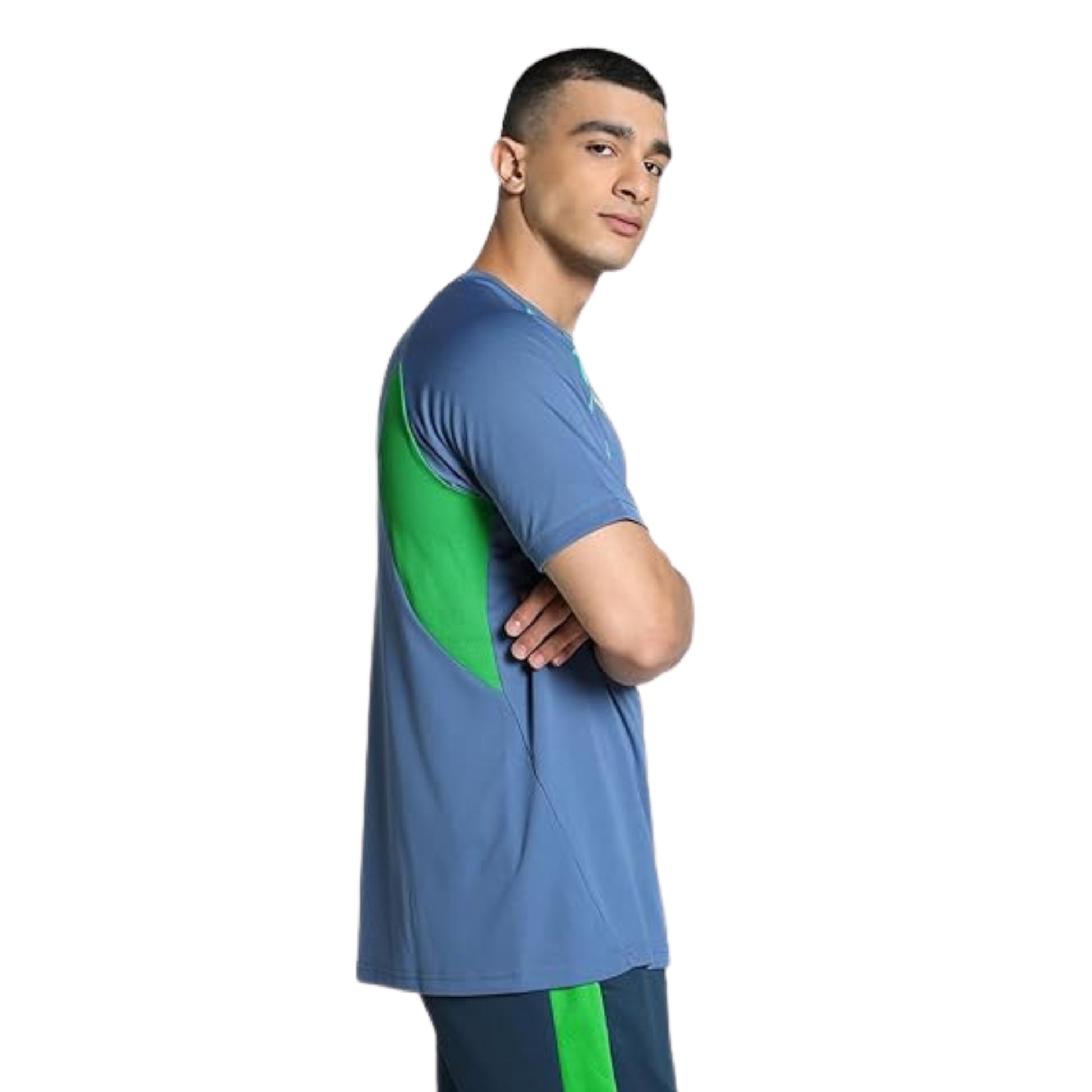 Man wearing a blue and green Puma soccer jersey on a white background